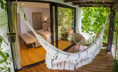 a hammock in a room with a bedroom at Patio del Mundo in Medellín