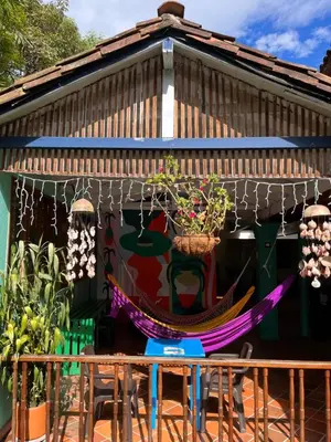 a hammock in the front of a house at Yolo Hostel Medellin in Medellín