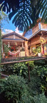 a house with a table and chairs in front of it at Yolo Hostel Medellin in Medellín