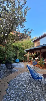 a group of chairs sitting on a gravel patio at Yolo Hostel Medellin in Medellín