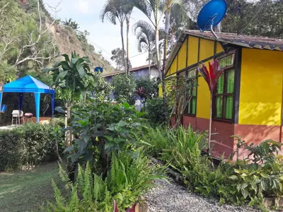 a colorful house with a balloon on top of it at Cabañas La Honda in Guatapé