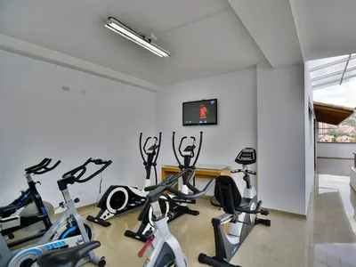 a gym with several exercise bikes in a room at Hotel Monarca in Medellín