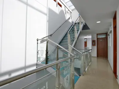 an empty hallway in a hospital with stairs at Hotel Monarca in Medellín