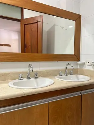 a bathroom with two sinks and a mirror at Hotel Monarca in Medellín