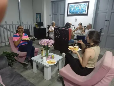 a group of people sitting in chairs eating food at ANGIE`s HOUSE in Manizales