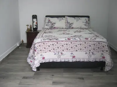 a bedroom with a bed with a floral bedspread at ANGIE`s HOUSE in Manizales