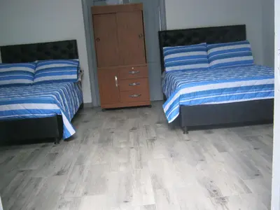 a bedroom with two beds and a dresser at ANGIE`s HOUSE in Manizales
