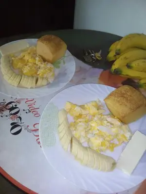 two plates of breakfast food on a table with bananas at ANGIE`s HOUSE in Manizales