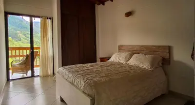 a bedroom with a bed and a balcony at La Casa Del Sol in Jardin