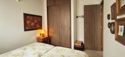 a bedroom with a bed and a table with a lamp at La Casa Del Sol in Jardin