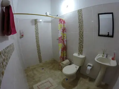 a bathroom with a toilet and a sink at Fami Hotel Vive Jardin in Jardin