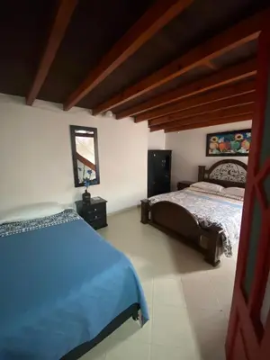 a bedroom with two beds and a mirror at Europa Ecotours in Jardin