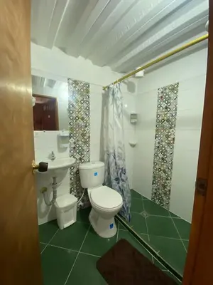 a bathroom with a toilet and a sink at Europa Ecotours in Jardin