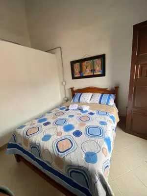 a bedroom with a bed with a colorful comforter at Europa Ecotours in Jardin