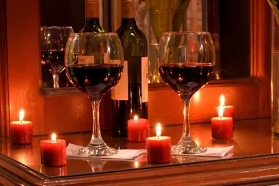 a table with two glasses of wine and candles at Las Marías Family Home - Urbano & Campestre in Salamina