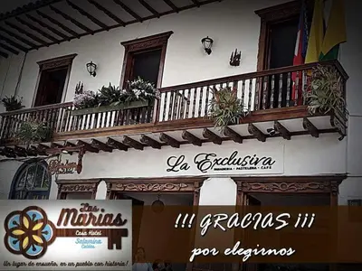 a building with a balcony with flowers on it at Las Marías Family Home - Urbano & Campestre in Salamina