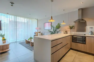 a kitchen with a counter and a living room at Soul Lifestyle Hotel in Medellín