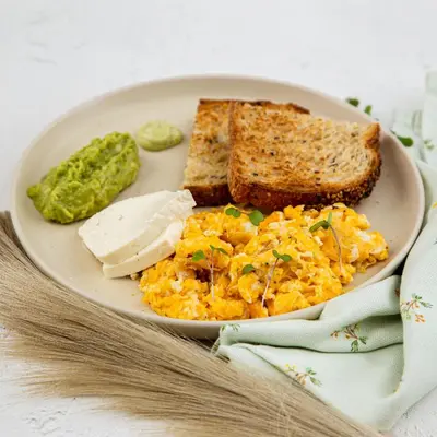 a plate of food with eggs and toast and pickles at Soul Lifestyle Hotel in Medellín