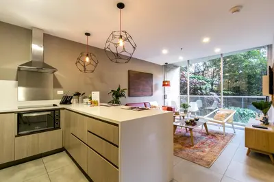 a kitchen with a counter and a living room at Soul Lifestyle Hotel in Medellín