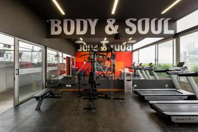 a gym with lots of cardio equipment and a sign at Soul Lifestyle Hotel in Medellín