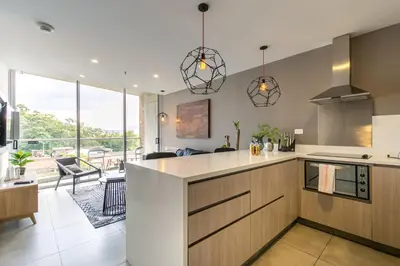 an open kitchen with a view of a living room at Soul Lifestyle Hotel in Medellín