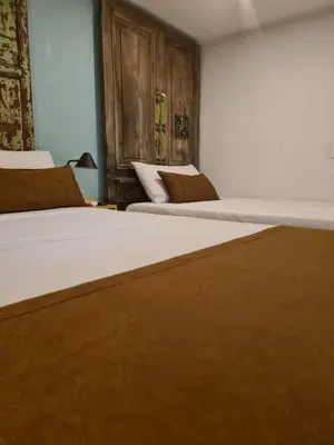 two beds sitting next to each other in a bedroom at Rivière Boutique Hotel in Medellín