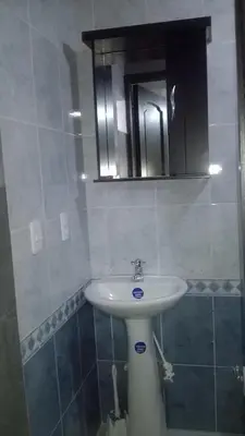 a bathroom with a sink and a mirror at Apartaestudios El Cable in Manizales