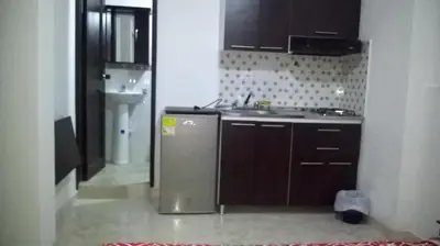 a small kitchen with a sink and a refrigerator at Apartaestudios El Cable in Manizales