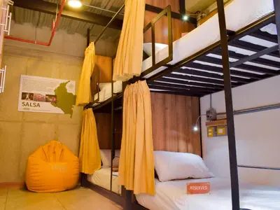 a room with two bunk beds with yellow umbrellas at Los Patios Hostel Medellin in Medellín