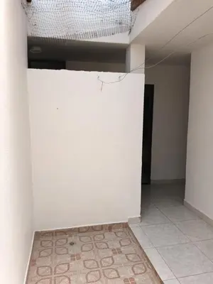 a room with a white wall and a tile floor at Hotel Internacional Jardín in Jardin