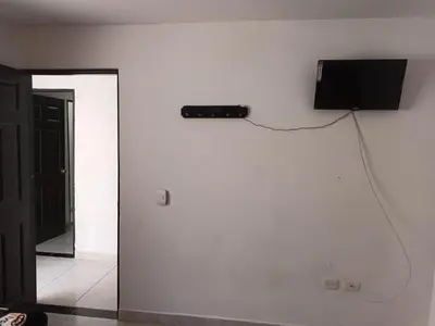 a television on a white wall in a room at Hotel Internacional Jardín in Jardin