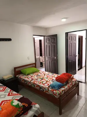 a bedroom with two beds and a mirror at Hotel Internacional Jardín in Jardin