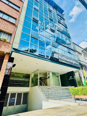 a building with glass windows and stairs in front of it at Hotel Laureles Plaza in Medellín