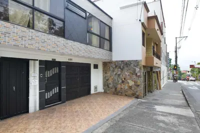 a building with black garage doors on a street at The Lofts @ 11 in Medellín