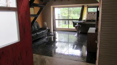 a living room with a black couch and a table at The Lofts @ 11 in Medellín