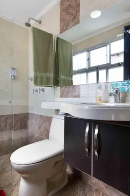 a bathroom with a toilet and a sink at The Lofts @ 11 in Medellín
