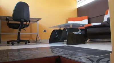 a room with a desk and a chair and a bed at The Lofts @ 11 in Medellín