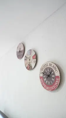 three clocks on the wall of a room at Hotel Salamanca Resort in Itagüí