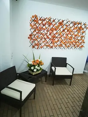 a living room with two chairs and a painting on the wall at Hotel Salamanca Resort in Itagüí
