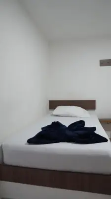 a bed with a blue robe laying on it at Hotel Salamanca Resort in Itagüí