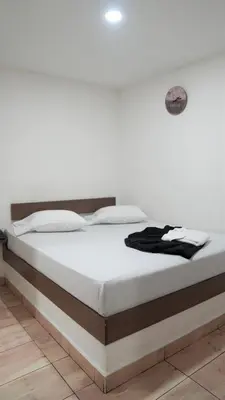 a bed in a room with a white wall at Hotel Salamanca Resort in Itagüí