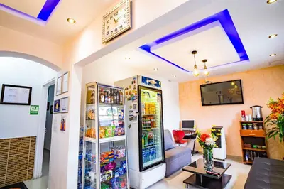 a living room with a refrigerator filled with drinks at Hotel Casa 10 in Medellín