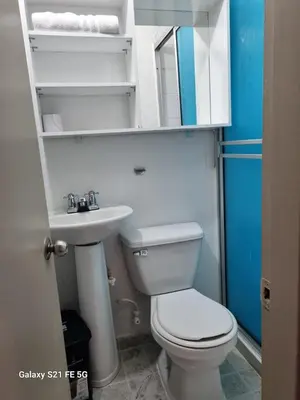 a small bathroom with a toilet and a sink at Hotel Casa 10 in Medellín