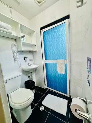 a bathroom with a toilet and a sink and a shower at Hotel Casa 10 in Medellín