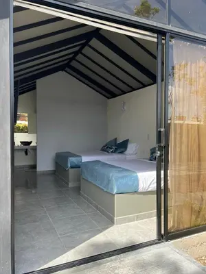 a bedroom with a bed under a roof at STAR CENTER Hotel Boutique in Rionegro