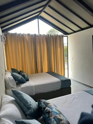 a bedroom with three beds and a window at STAR CENTER Hotel Boutique in Rionegro