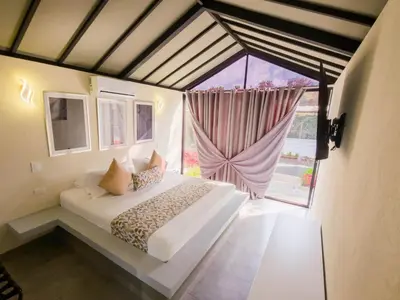 a bedroom with a bed and a large window at STAR CENTER Hotel Boutique in Rionegro