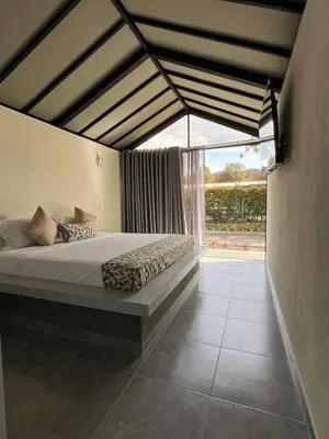 a bedroom with a bed and a large window at STAR CENTER Hotel Boutique in Rionegro