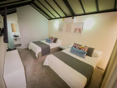 a room with two beds and a table with at STAR CENTER Hotel Boutique in Rionegro
