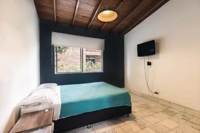 a bedroom with a bed and a window at Living Hotel in Medellín
